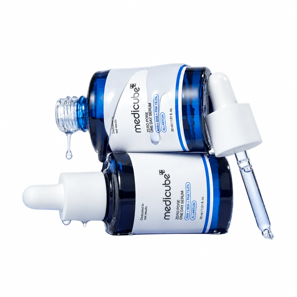 Two bottles of Medicube skincare products on a reflective surface with a white background